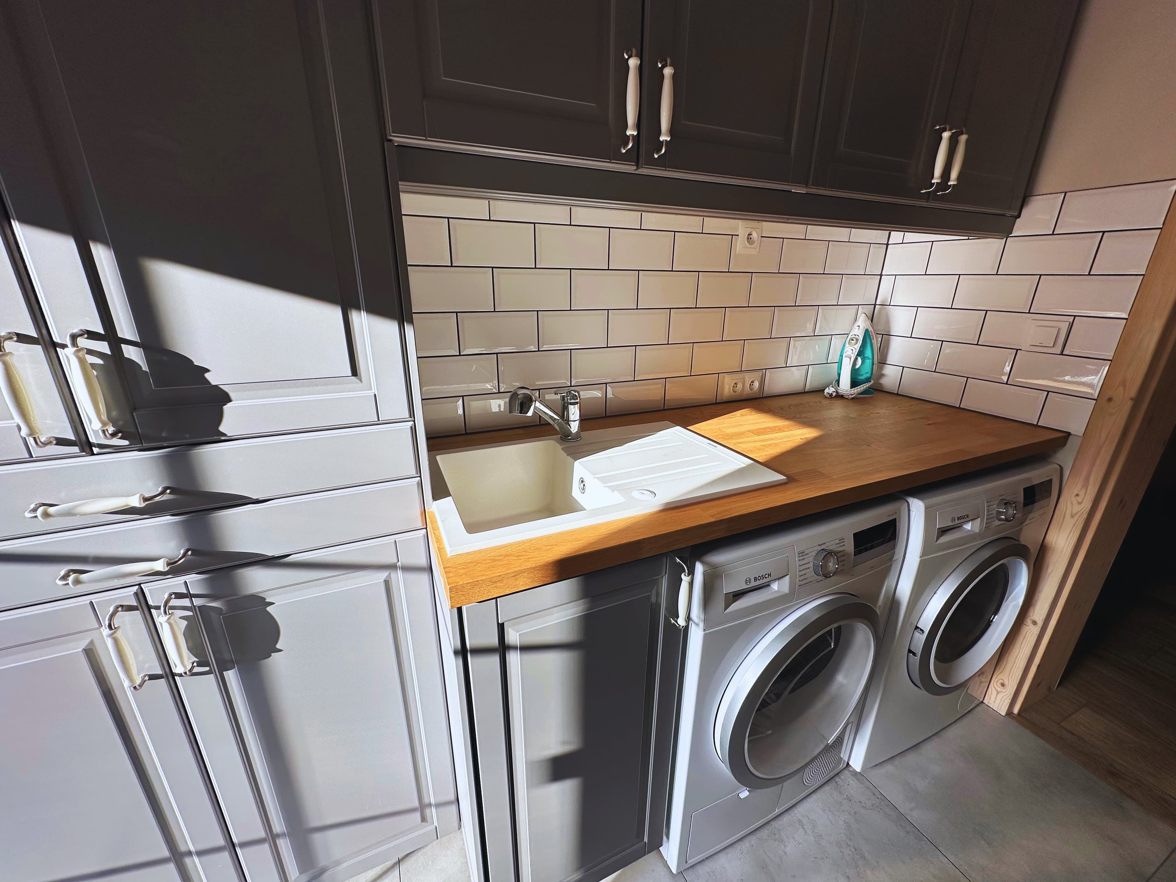 Close-up of laundry room showing sink and appliances