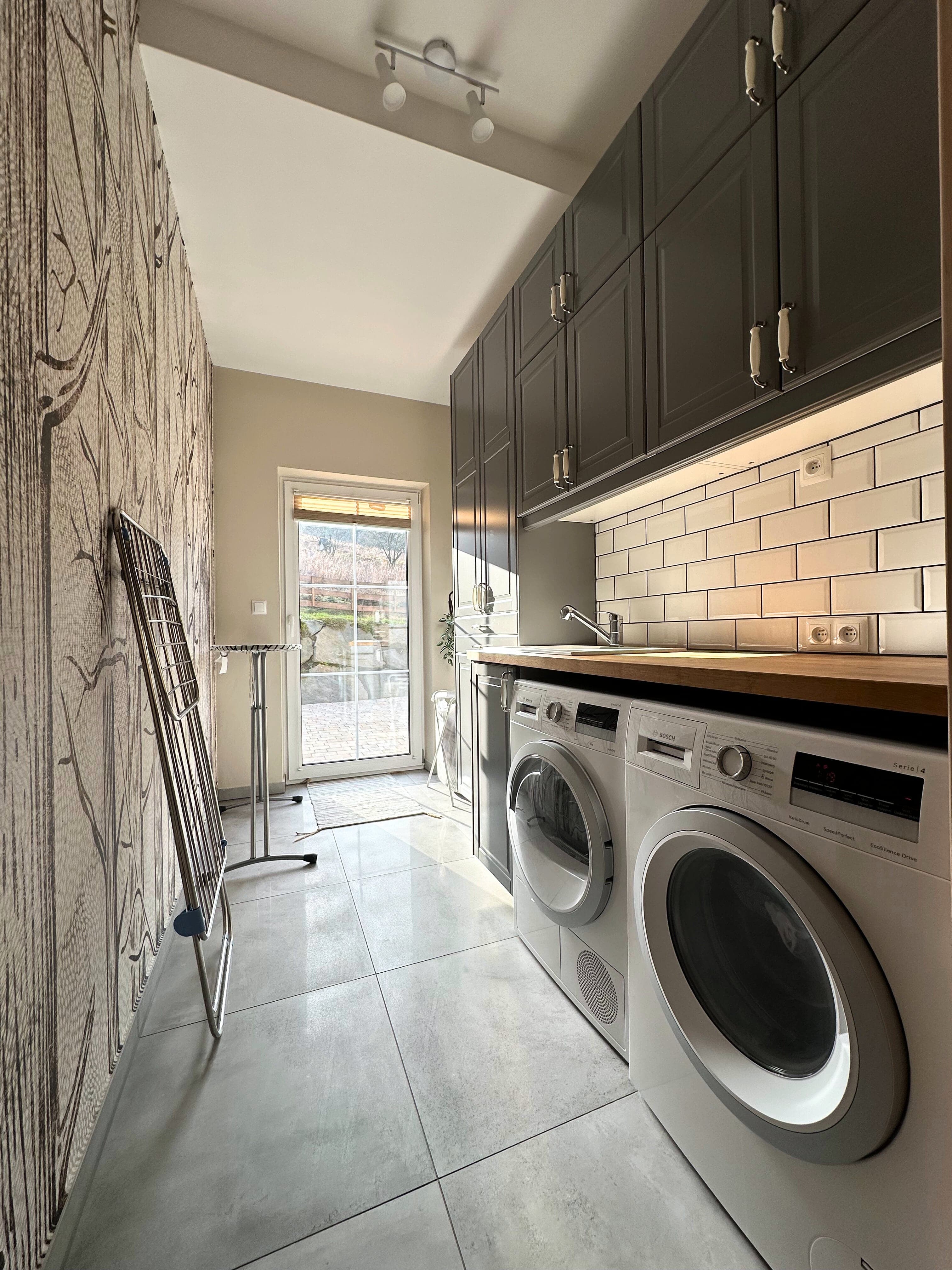 Full view of laundry room with cabinets and door